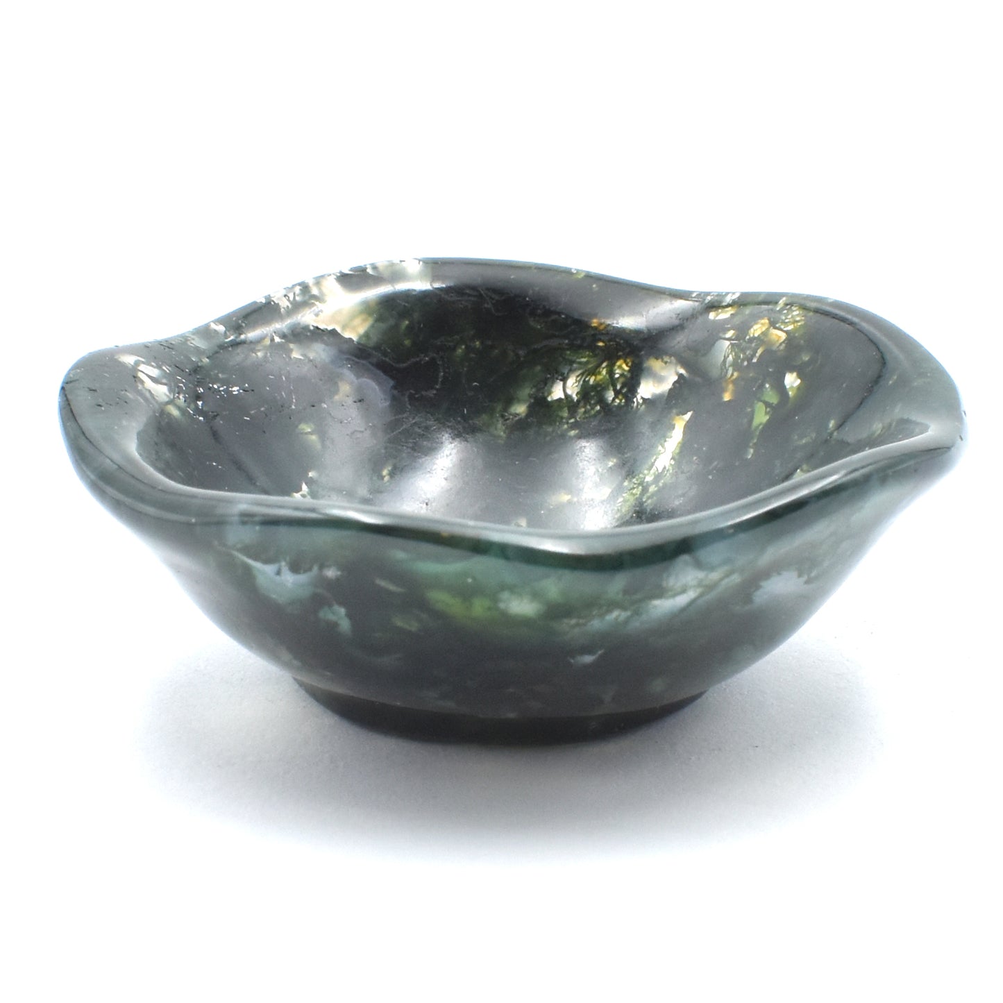 Deep green moss agate carved into a small polished bowl. stunning formations within and a wavy lining. side view