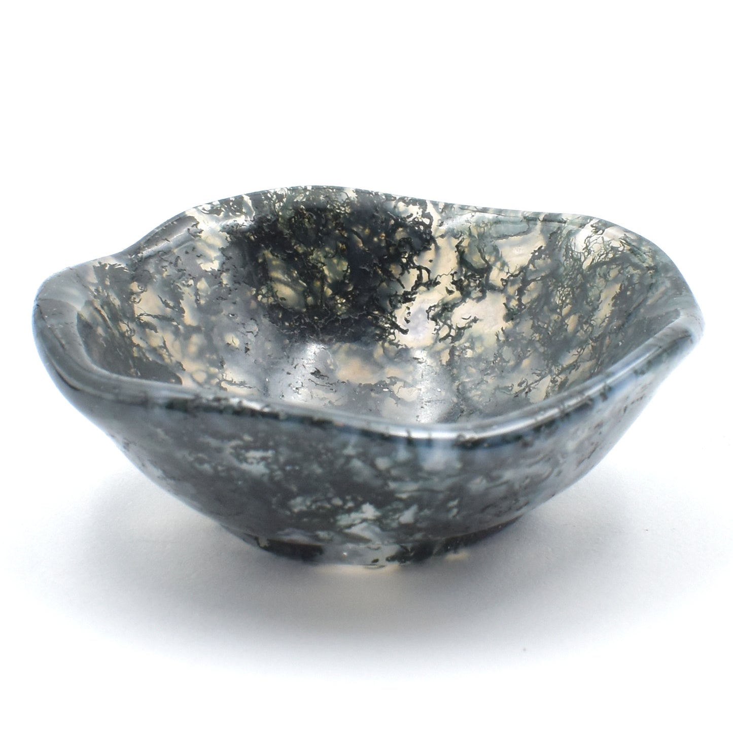 green moss agate carved into a small polished bowl. stunning formations within and a wavy lining. side view