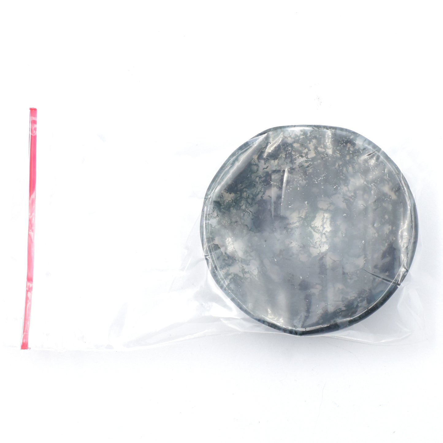 green moss agate carved into a small polished bowl. stunning formations within and a wavy lining. bowl being packaged.