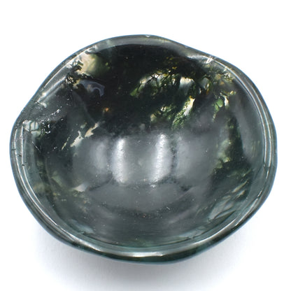 Deep green moss agate carved into a small polished bowl. stunning formations within and a wavy lining.  top view.