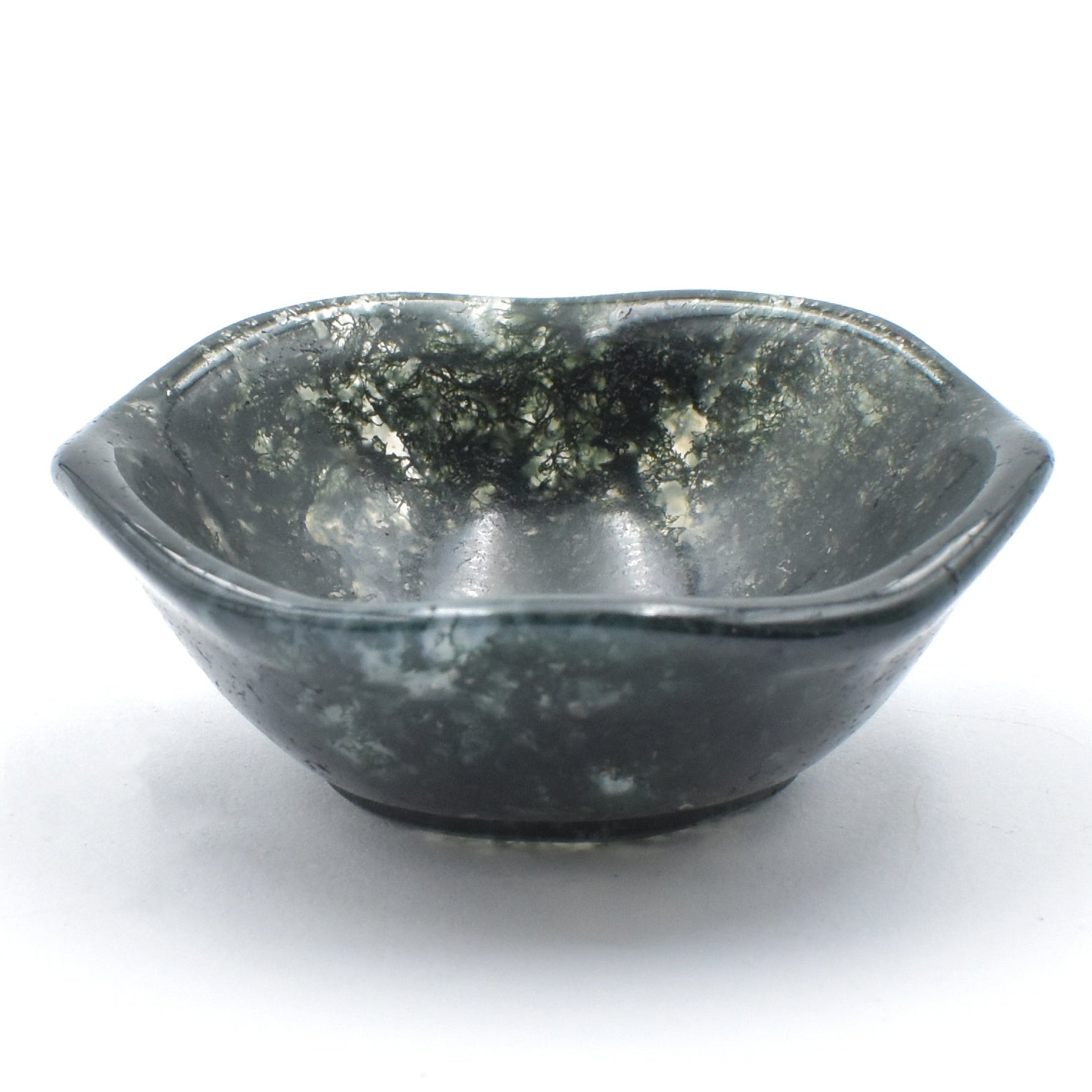 Deep green moss agate carved into a small polished bowl. stunning formations within and a wavy lining.  side view