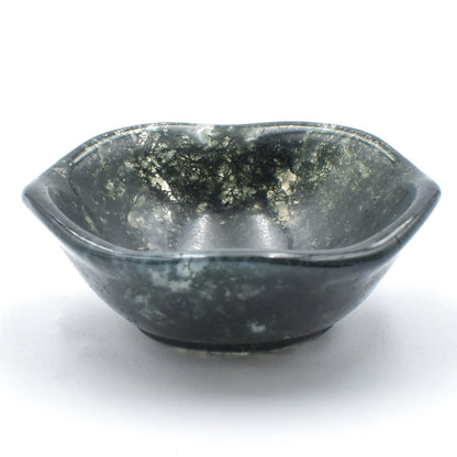 Deep green moss agate carved into a small polished bowl. stunning formations within and a wavy lining.  side view