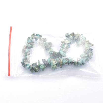 stunning green and black coloured elastic crystal chip bracelet. made using high quality african turquoise chips. bracelet being packed for order.