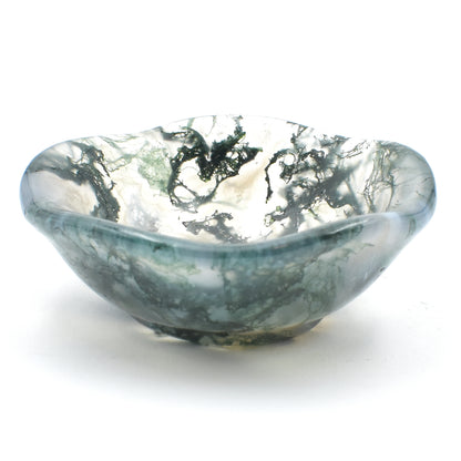 green moss agate carved into a small polished bowl. stunning formations within and a wavy lining. side view